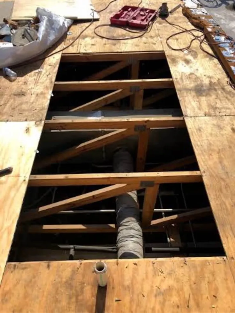 Extracting a core sample of roofing insulation to check for subsurface water capture