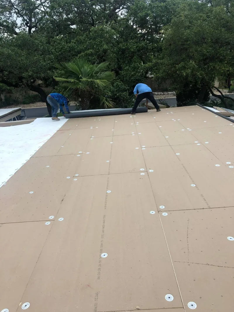 Panoramic view of a completed white reflective TPO membrane roof installation in Austin